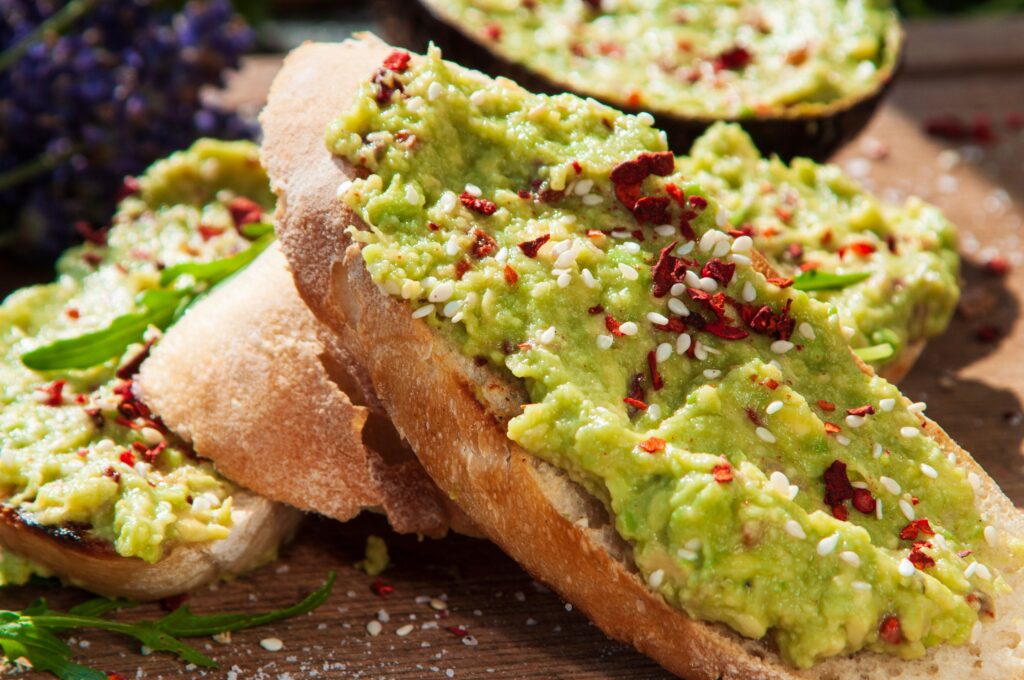Whole-grain toast topped with creamy avocado and fresh herbs