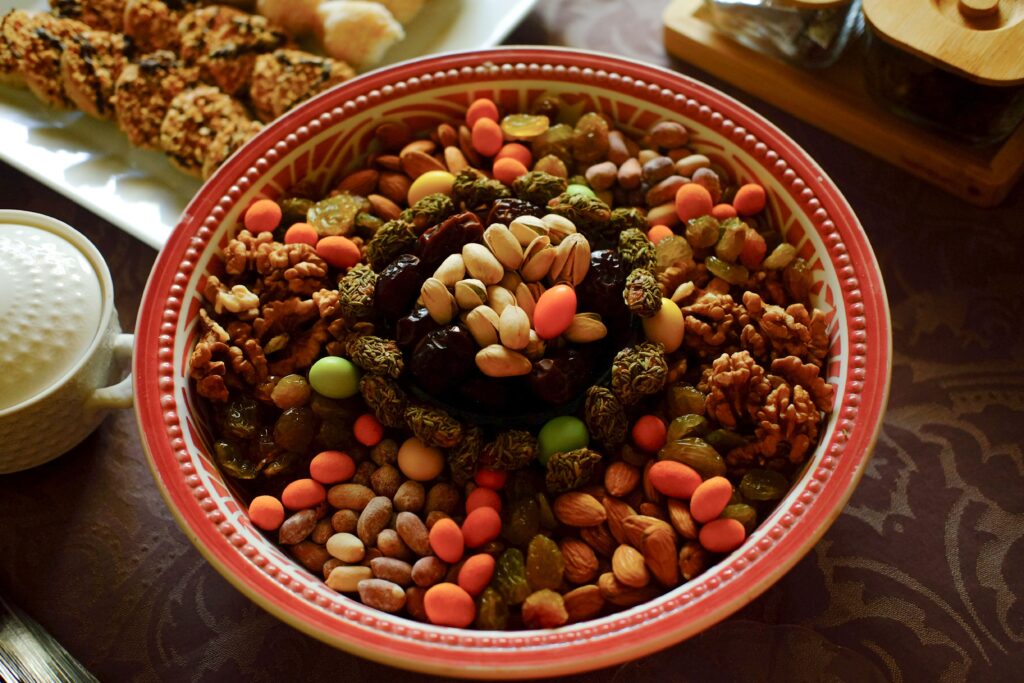 Colorful bowl of fresh fruits and mixed nuts served as a nutritious snack