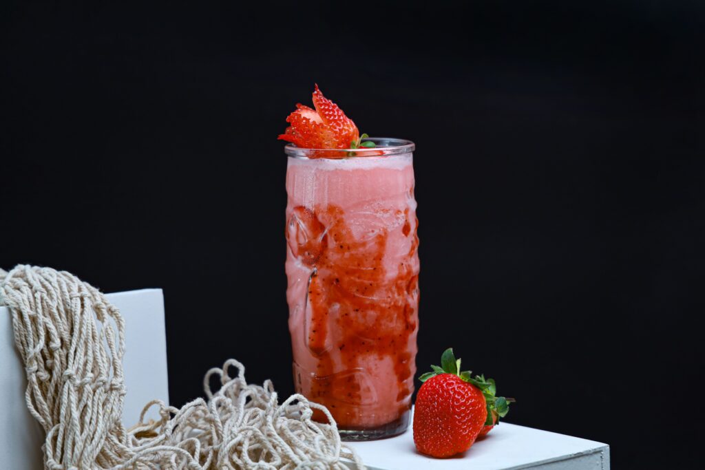 Fresh fruit smoothie served in a glass with colorful mixed fruits